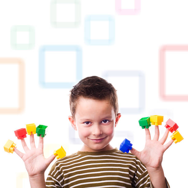 Playful boy Boy playing with plastic cubes on fingers... lepro stock pictures, royalty-free photos & images