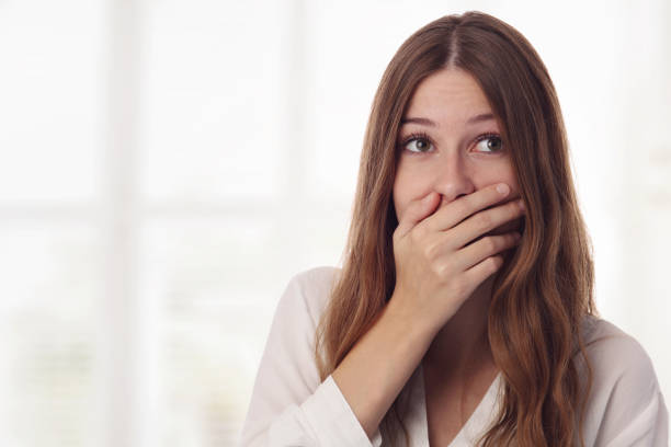 Playful, surprised, shy young woman hiding her face laughing timid. Playful, surprised, shy young woman hiding her face laughing timid. shy photos stock pictures, royalty-free photos & images