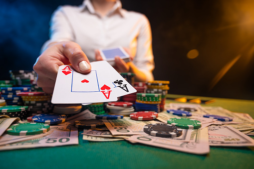 Playing In A Casino Online Casino A Player Opens Cards With Two Aces Money  Poker Table Chips Background For The Gaming Business And Online Casinos  Stock Photo - Download Image Now - iStock