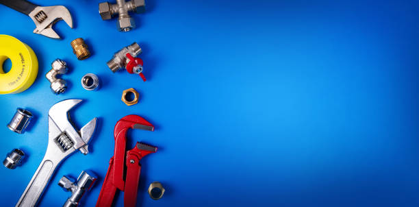 plumbing tools and fittings on blue background with copy space plumbing tools and fittings on blue background with copy space water pipe stock pictures, royalty-free photos & images