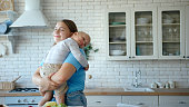 istock Plump mom holds toddler in arms gently and smiles happily 1347940883