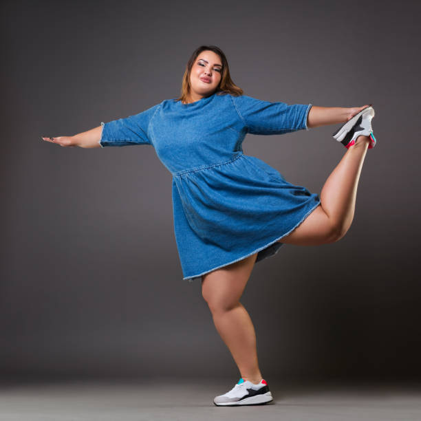Plus size fashion model in casual clothes, fat woman on gray background, overweight female body Plus size fashion model in casual clothes, fat woman on gray background, overweight female body, full length portrait beautiful voluptuous women stock pictures, royalty-free photos & images
