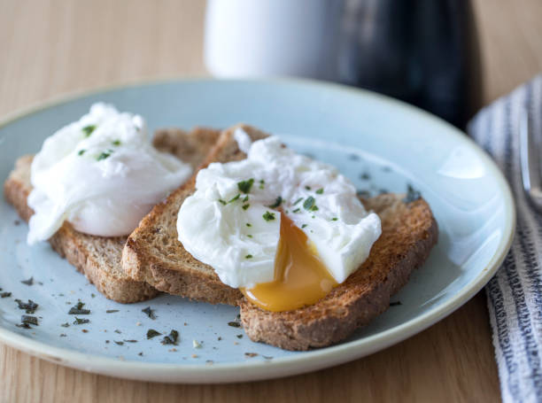 Poached eggs on toast with yolk flow Poached eggs on toast with yolk flow poached food stock pictures, royalty-free photos & images