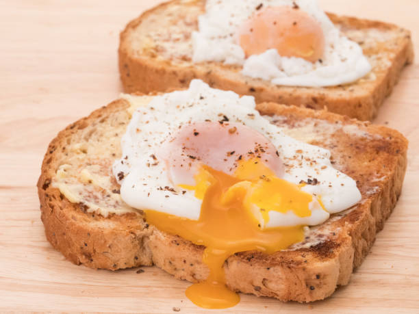 Poached eggs Two poached eggs on toast poached food stock pictures, royalty-free photos & images