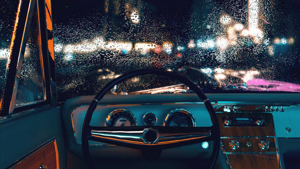 Point of view from the driver seat from a vintage car parked at night stock photo