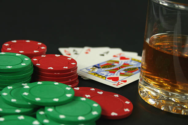 poker chips, cards and bourbon stock photo