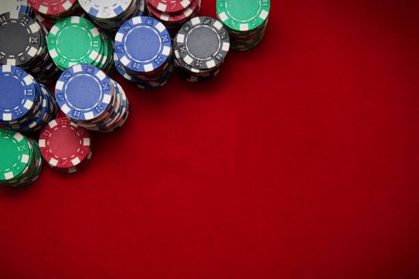 Poker chips on red background Poker chips on red background gambling chip stock pictures, royalty-free photos & images