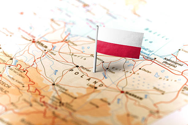 The flag of Poland pinned on the map. Horizontal orientation. Macro photography.
