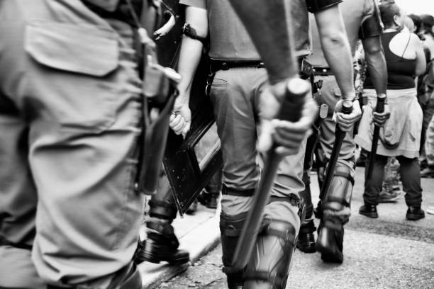 Police and Batons January 11, 2017: Police officers surround demonstrators during an act against the increase in public transportation fares in the city of São Paulo in Brazil repression stock pictures, royalty-free photos & images