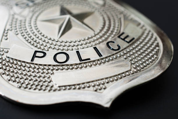 Police badge macro photo on black background Silver police badge macro photo on black background. police badge stock pictures, royalty-free photos & images