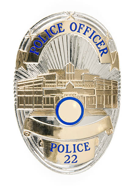 Police Badge Close-up of a police officer's badge.  Badge number has been altered. Badge made/designed by SymbolArts.  Property released by manufacturer. police badge stock pictures, royalty-free photos & images