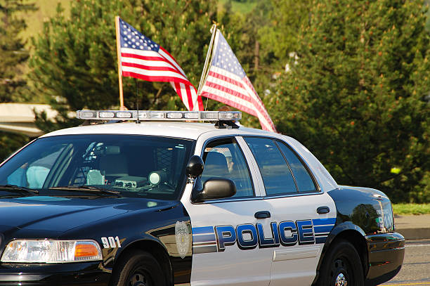 Police car with two American flags on top stock photo