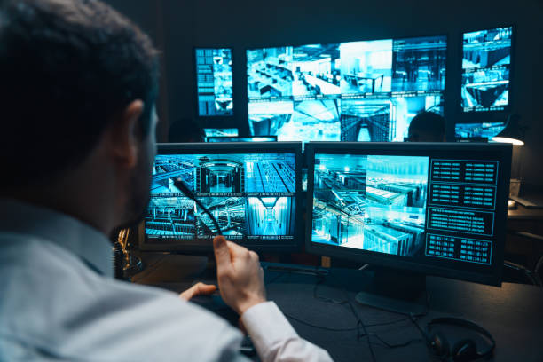 Police officers at surveillance control center wide stock photo