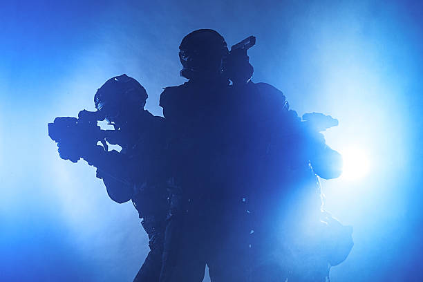 Police officers SWAT Police officers SWAT in black uniform in the smoke studio shot special forces stock pictures, royalty-free photos & images