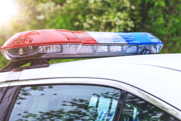Police patrol car with sirens off during a traffic control. Blue and red flashing sirens of police car during the roadblock in the city. stock photo