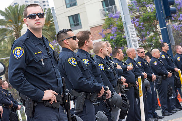 Police presence at Trump rally San Diego, California, USA - May 27, 2016: San Diego police officers stand on watch in an effort to keep the peace at an anti-Trump demonstration outside a Trump rally at the San Diego Convention Center. donald trump stock pictures, royalty-free photos & images