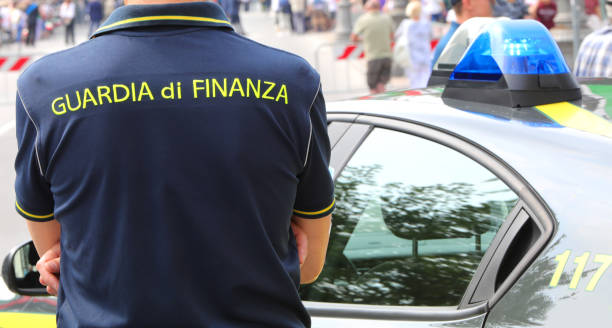 Policeman with uniform and text GUARDIA DI FINANZA that means Financial Police in italian language stock photo
