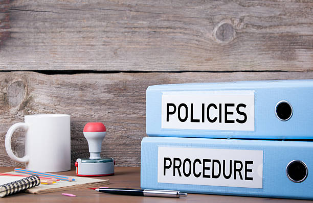 Policies and Procedure. Two binders on desk stock photo