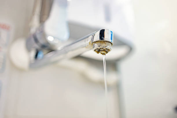 Polluted and calcified water in our homes. Close up of a limescale tap with polluted water. stock photo