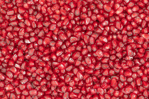 Natural background of red seeds of pomegranate
