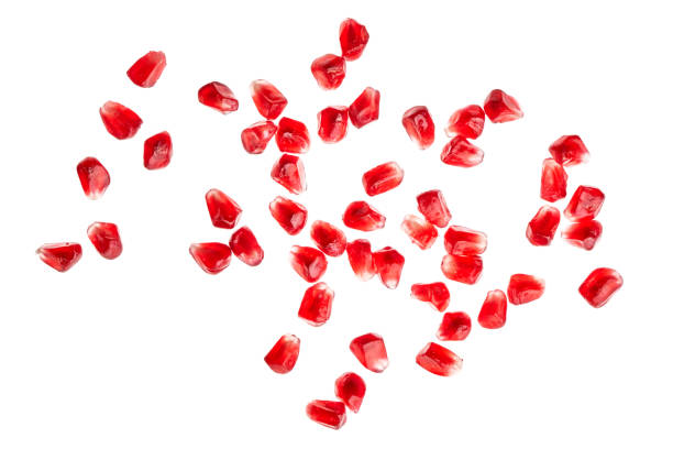 pomegranate seeds on white background stock photo