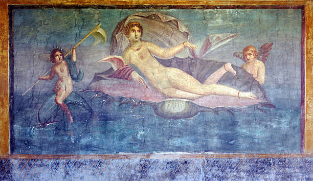Pompeii Venus Marina "An Ancient Roman fresco/mural decorating the wall of an ancient villa - buried in A.D 79 when Vesuvius eruptedThis painting shows Venus on a half shell with Cupid and a nereid on a dolphin. The Venus is described as having curls, a billowing shawl and golden jewelry. It is on the rear wall of the peristyle.Pompeii, ItalyThe mural is 2000 years old and now in the open air - hence it is dusty and marked in places" fresco stock pictures, royalty-free photos & images