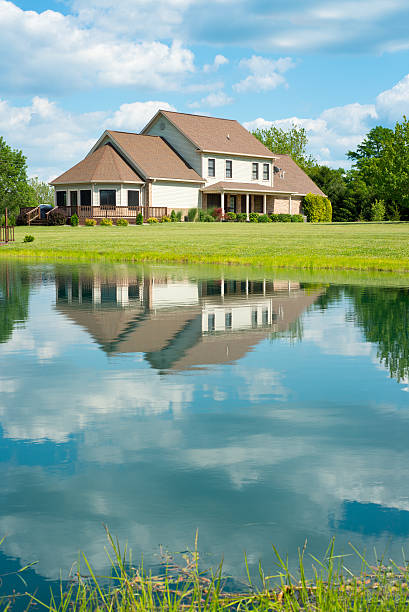 Pond Reflection of Home in the midwest Waterfront property the midwest. waterfront stock pictures, royalty-free photos & images
