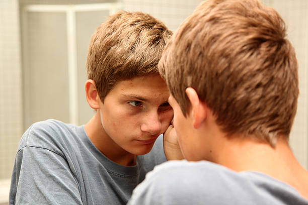 Pondering teenage boy stock photo