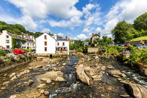 View of the river at low tide running through the romantic village Pont-Aven, a famous tourist resort in Brittany, France.

Logo’s and recognizeable people have been blurred.