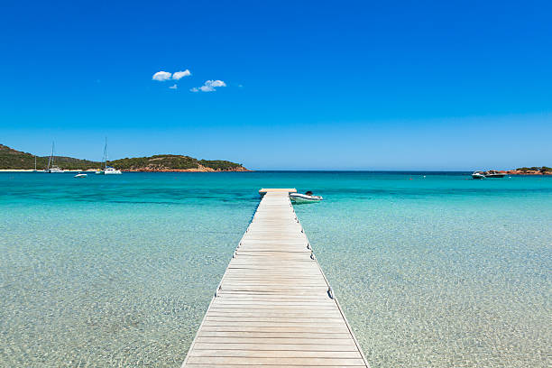 Pontoon  in the turquoise water of  Rondinara beach in Corsica Pontoon  in the turquoise water of  Rondinara beach in Corsica Island in France corsica stock pictures, royalty-free photos & images