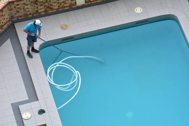 Pool Cleaner Cleaning a Pool Aerial view of a pool cleaner cleaning a pool. standing water stock pictures, royalty-free photos & images