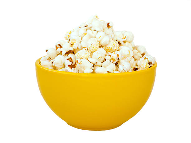 Popcorn in yellow bowl Popcorn in yellow ceramic bowl isolated on white popcorn stock pictures, royalty-free photos & images