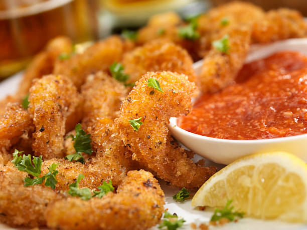 PopCorn Shrimp "PopCorn Shrimp with fresh Parsley, Lemon,Cocktail Sauce and a Couple of Beers- Photographed on Hasselblad H3D2-39mb Camera" cocktail sauce stock pictures, royalty-free photos & images