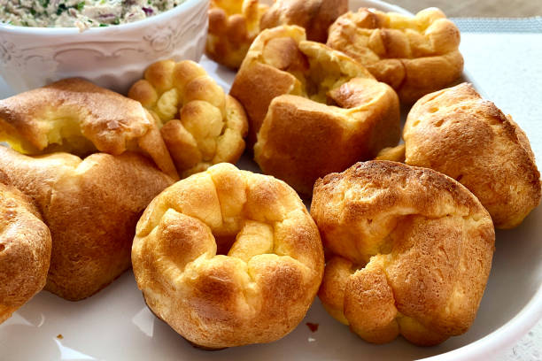 PopoversFresh popover muffins are served on a white platter. Yorkshire pudding stock photo