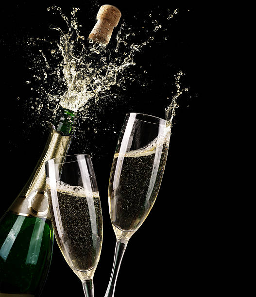 Popping Champagne And Toast Of Midnight Champagne Flutes for Celebratory Toast champagne stock pictures, royalty-free photos & images