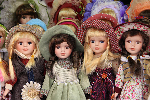 Porcelain dolls in Prague market, sold as souvenirs Porcelain dolls for children, dressed withcolorful hats and dresses in Prague market, sold as souvenirs. doll stock pictures, royalty-free photos & images