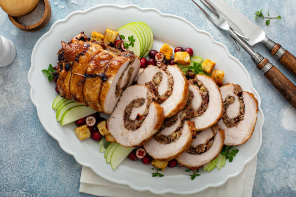 Pork loin roasted filled with cranberry stuffing stock photo