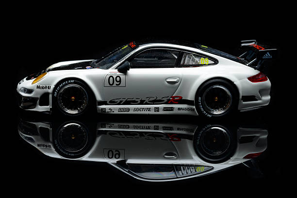 Porsche 911 GT3 RSR 2016 race car model Kampen, The Netherlands - February 18, 2016: Scale model of a Porsche 911 GT3 RSR race car isolated on a black background with a reflection in the foreground. porsche 911 stock pictures, royalty-free photos & images