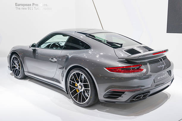 Porsche 911 Turbo S sports car Brussels, Belgium - Januari 12, 2016: Gray Porsche 911 Turbo S sports car rear view. The 911 Turbo S is fitted with a 3.8-liter six cylinder Turbo engine producing 580 horsepower. The car is on display during the 2016 Brussels Motor Show. The car is displayed on a motor show stand, with lights reflecting off of the body.  porsche 911 stock pictures, royalty-free photos & images