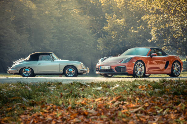 Porsche boxter classic versus New model Porsche boxter classic versus new model, colorful photo, red and silver car, classsic car and modern car in the same photo.Photo was made in Serbia with idea to compare same model of the car from past century and newer age. Photo was made in november 2015 and on the photo is very rare classic Porsche. Idea was to present design and concept from the past comparing to modern car today. Photographed outdoor. porsche 911 stock pictures, royalty-free photos & images