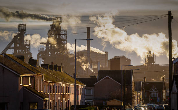 Port Talbot Steel works Editorial PORT TALBOT, UK - JANUARY 04, 2020: The houses of Port Talbot and the emissions of the TATA Steel works that provides employment for the townsfolk. steel mill stock pictures, royalty-free photos & images