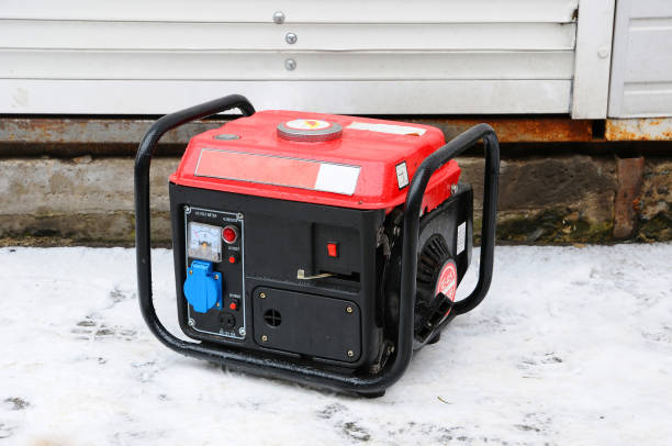 Portable electric generator running in the cold winter. stock photo