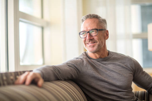 Portarit of a handsome older man sitting on a sofa