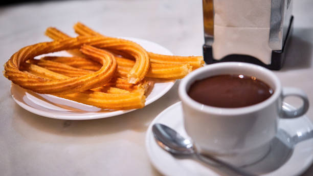 Portion of hot Madrid Churros served on a table. stock photo