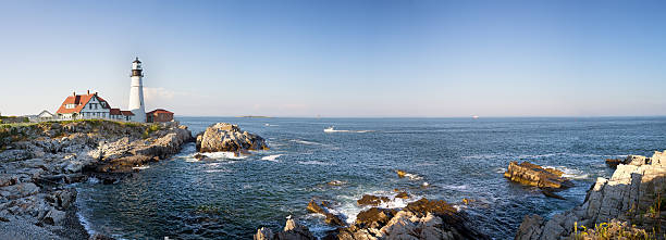 Portland Head Lighthouse panorama A panorama of the Portland Head lighthouse and rugged coastline, Maine, USA maine stock pictures, royalty-free photos & images