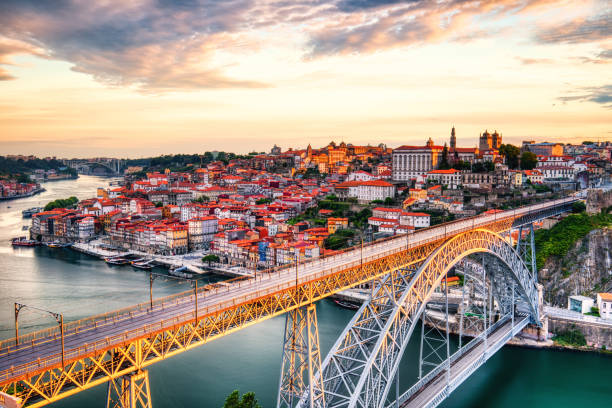 Porto Aerial Cityscape with Illuminated Luis I Bridge and Douro River at Amazing Sunrise stock photo