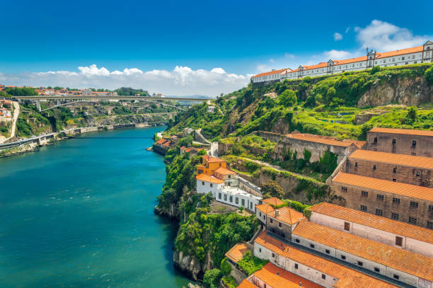 porto, portugal: hills of vila nova de gaia and wine cellars over duoro river - oporto imagens e fotografias de stock
