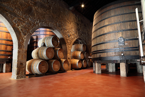 Old fashioned Porto wine cellar with wooden barrels in Porto, Portugal