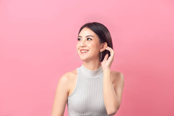 Portrait Asian woman smiling on  pink background. Beautiful Asian woman short hair smiling in studio pink background. beautiful hair asian lady stock pictures, royalty-free photos & images