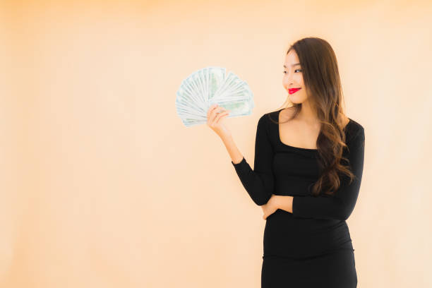 Portrait beautiful young asian woman smile happy with money and cash stock photo